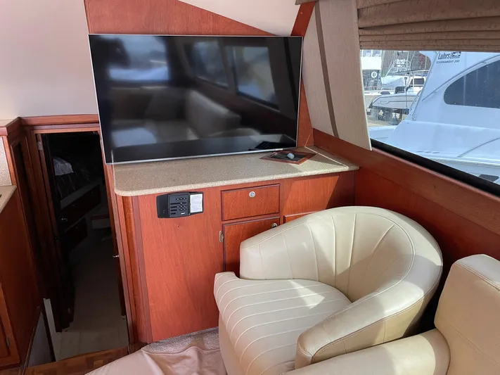 On Course Yacht Photos Pics Interior of 1986 Egg Harbor 41 Convertible yacht with TV and cream chair.