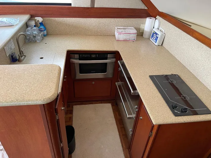 On Course Yacht Photos Pics 1986 Egg Harbor 41 Convertible yacht kitchen with stove, oven, and countertop.