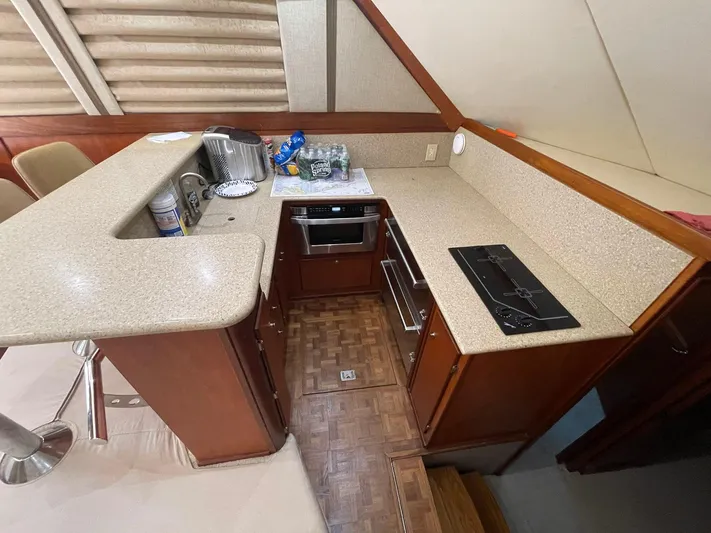 On Course Yacht Photos Pics 1986 Egg Harbor 41 Convertible yacht kitchen with modern appliances and wooden cabinetry.