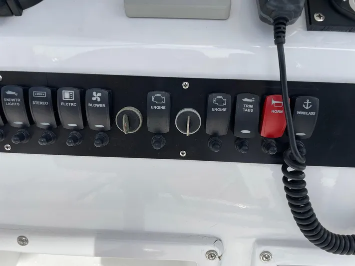 On Course Yacht Photos Pics Control panel of a 1986 Egg Harbor 41 Convertible boat with various switches and knobs.