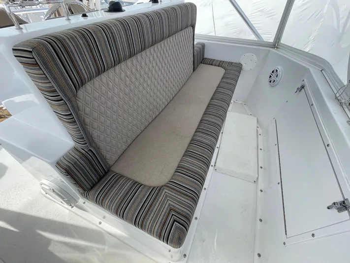 On Course Yacht Photos Pics 1986 Egg Harbor 41 Convertible boat interior with striped cushioned seating.