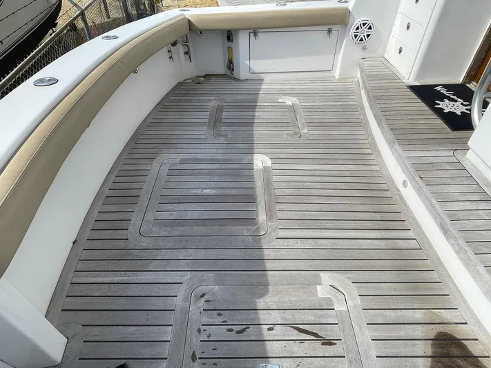 On Course Yacht Photos Pics 1986 Egg Harbor 41 Convertible boat deck with teak flooring and cushioned seating.