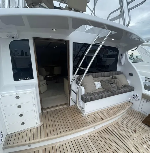 On Course Yacht Photos Pics 1986 Egg Harbor 41 Convertible yacht with teak deck, cushioned seating, and ladder access.