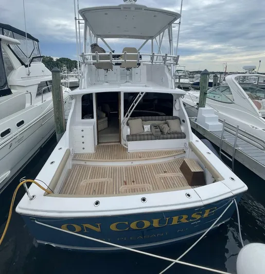 On Course Yacht Photos Pics 1986 Egg Harbor 41 Convertible yacht docked, featuring spacious deck and seating area.