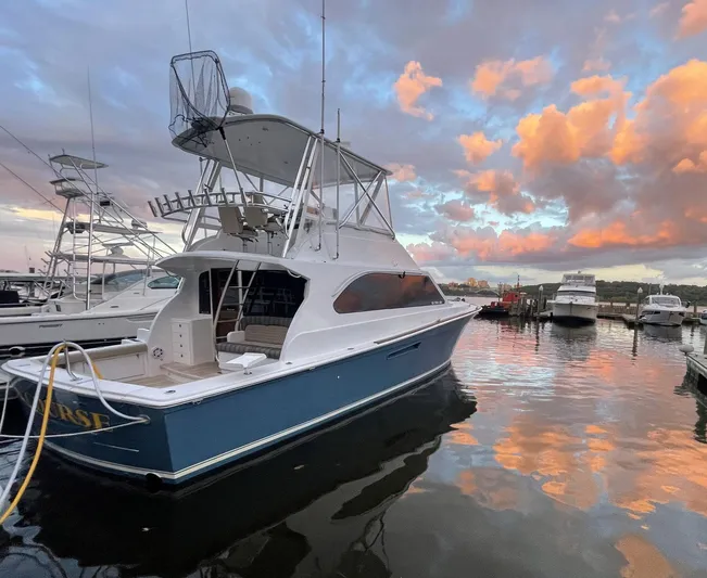 On Course Yacht Photos Pics 1986 Egg Harbor 41 Convertible yacht docked at sunset with vibrant sky reflections.