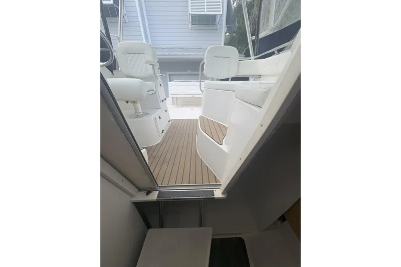  Yacht Photos Pics 2001 Boston Whaler 285 Conquest interior with white seating and wooden flooring.