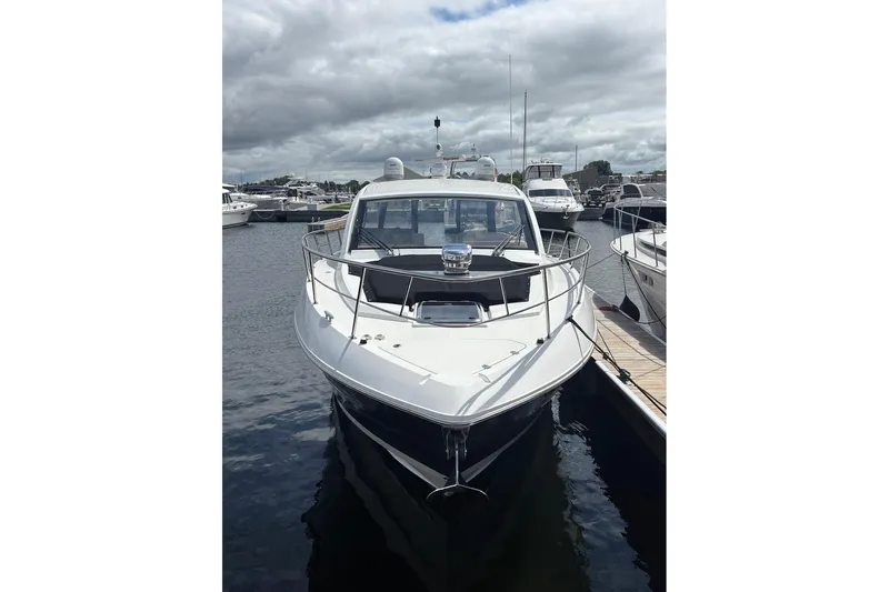  Yacht Photos Pics 2017 Cruisers Yachts 39 Express Coupe docked at marina under cloudy sky.