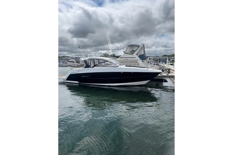  Yacht Photos Pics 2017 Cruisers Yachts 39 Express Coupe docked in a marina under cloudy skies.