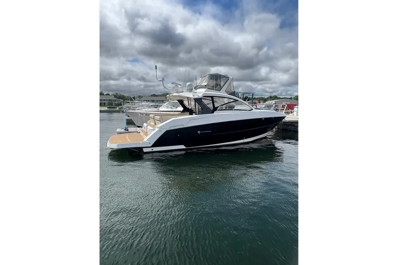  Yacht Photos Pics 2017 Cruisers Yachts 39 Express Coupe on water, cloudy sky background.