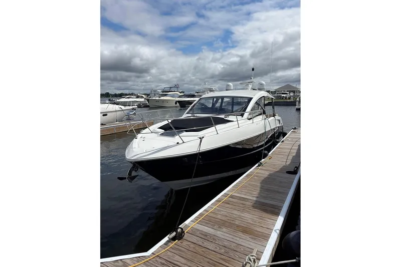  Yacht Photos Pics 2017 Cruisers Yachts 39 Express Coupe docked at marina under cloudy sky.