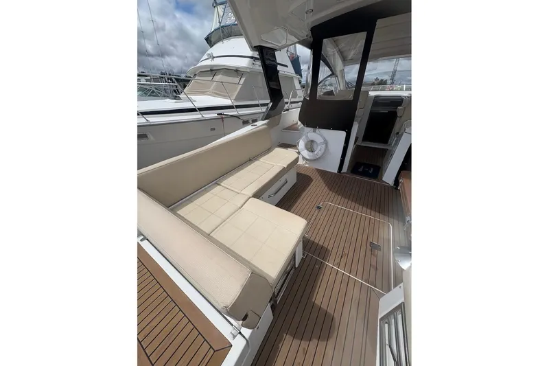  Yacht Photos Pics 2017 Cruisers Yachts 39 Express Coupe interior with beige seating and wooden flooring.