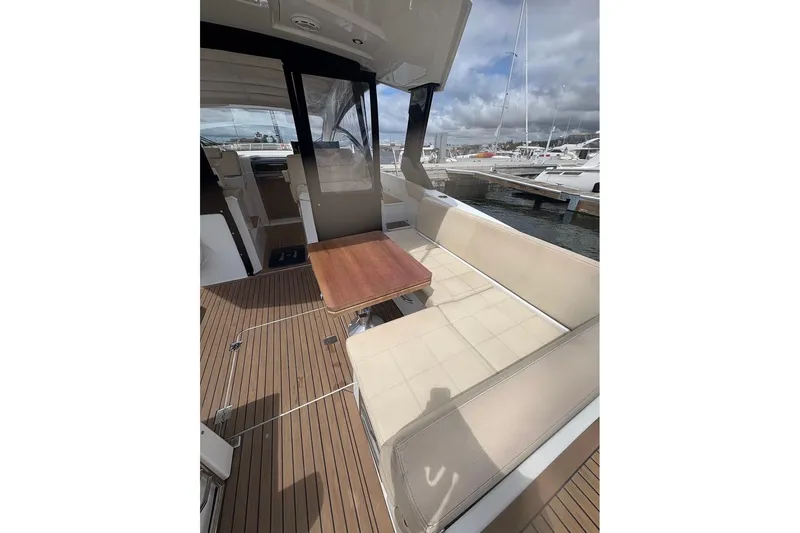  Yacht Photos Pics 2017 Cruisers Yachts 39 Express Coupe interior with seating and table, docked at marina.