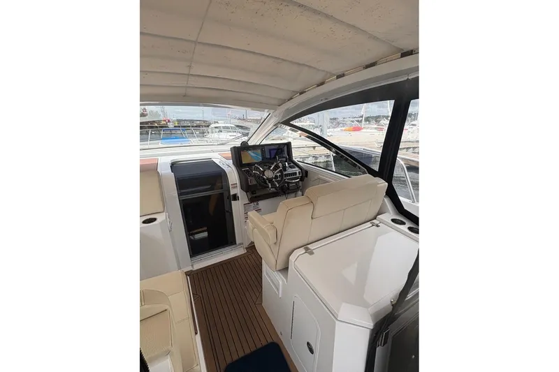 Yacht Photos Pics 2017 Cruisers Yachts 39 Express Coupe interior with helm and seating area.