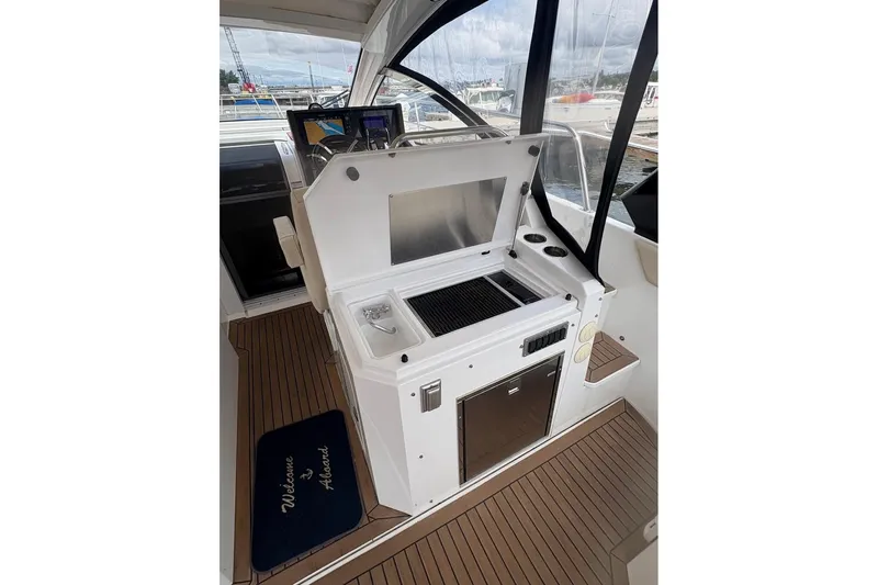  Yacht Photos Pics 2017 Cruisers Yachts 39 Express Coupe interior with kitchenette and welcome mat.