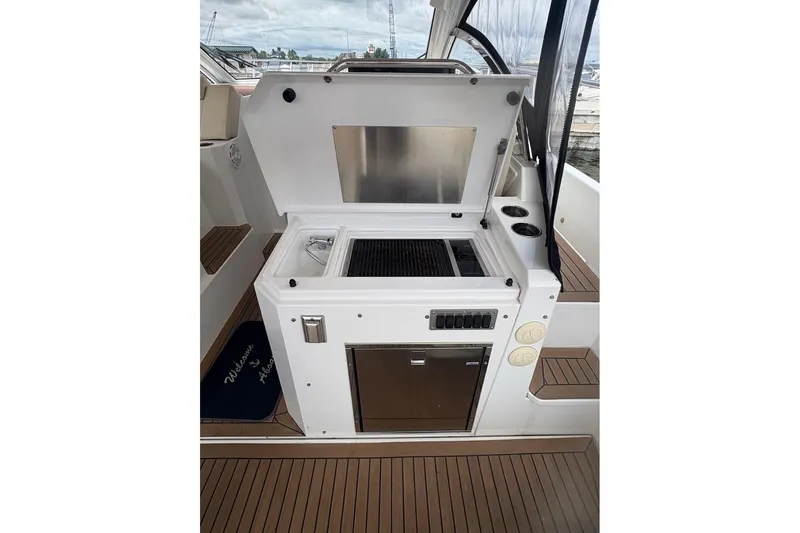  Yacht Photos Pics 2017 Cruisers Yachts 39 Express Coupe outdoor kitchen with grill and sink.