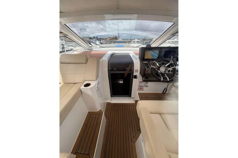  Yacht Photos Pics 2017 Cruisers Yachts 39 Express Coupe cockpit with steering wheel and navigation screens.