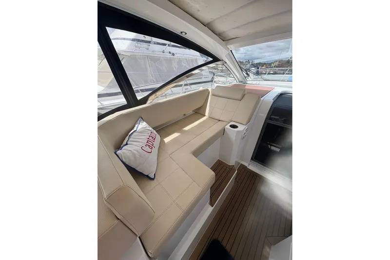  Yacht Photos Pics 2017 Cruisers Yachts 39 Express Coupe interior with beige seating and "Captain" pillow.