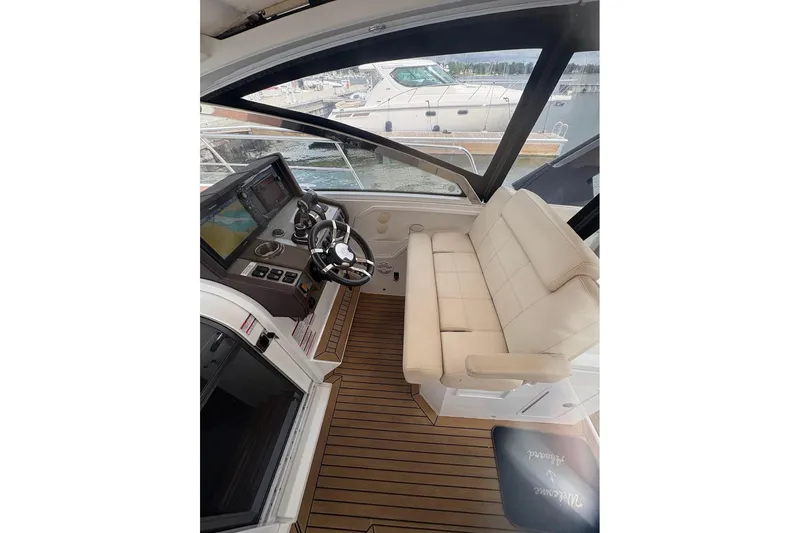  Yacht Photos Pics 2017 Cruisers Yachts 39 Express Coupe helm with leather seating and modern controls.