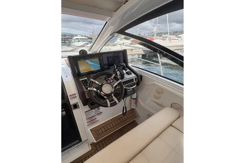  Yacht Photos Pics 2017 Cruisers Yachts 39 Express Coupe helm with navigation screens and steering wheel.