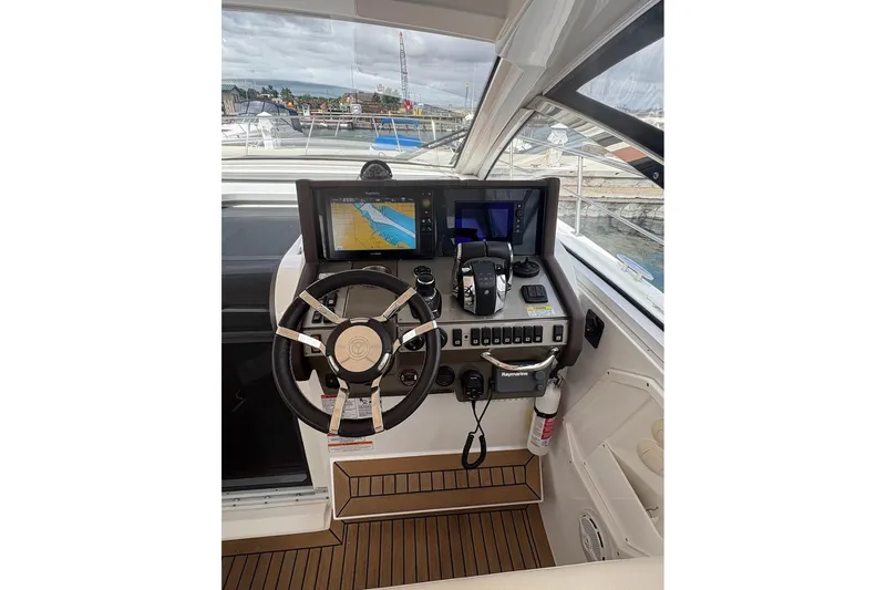  Yacht Photos Pics 2017 Cruisers Yachts 39 Express Coupe helm with navigation screens and controls.