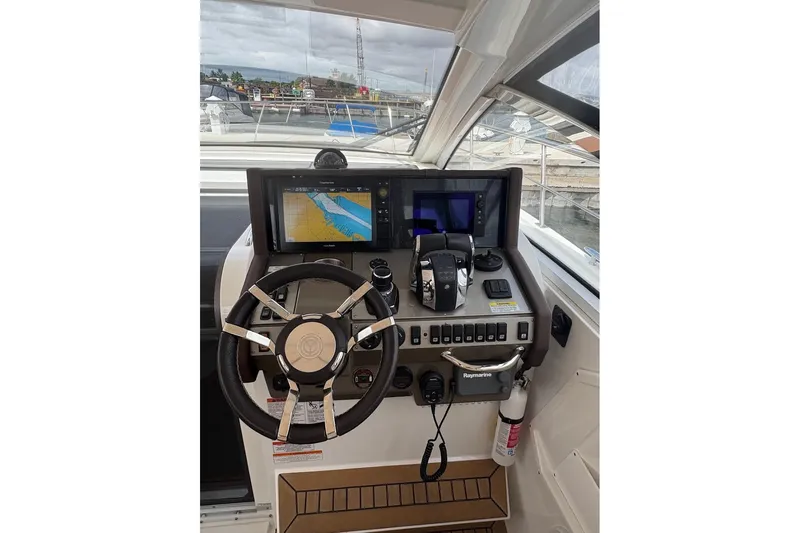  Yacht Photos Pics 2017 Cruisers Yachts 39 Express Coupe helm with navigation screens and controls.