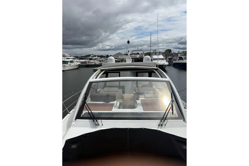  Yacht Photos Pics 2017 Cruisers Yachts 39 Express Coupe docked at marina under cloudy sky.