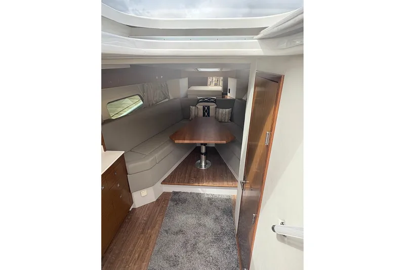  Yacht Photos Pics 2017 Cruisers Yachts 39 Express Coupe interior with cozy seating and wooden table.