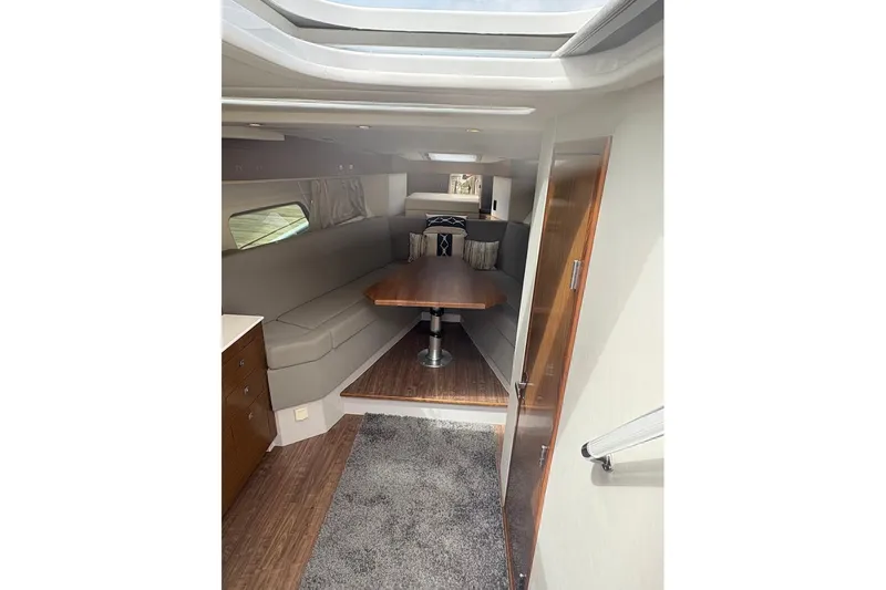  Yacht Photos Pics 2017 Cruisers Yachts 39 Express Coupe interior with cozy seating and wooden table.