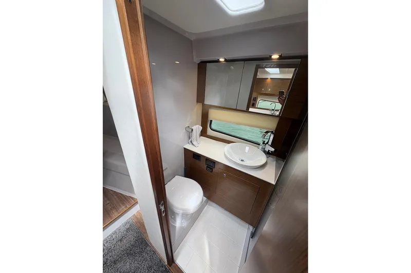  Yacht Photos Pics 2017 Cruisers Yachts 39 Express Coupe bathroom with modern fixtures and wood accents.