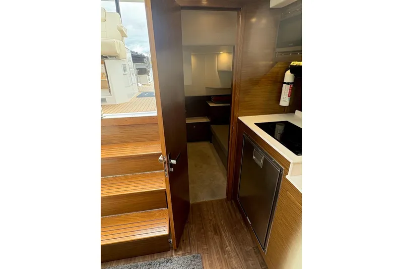  Yacht Photos Pics 2017 Cruisers Yachts 39 Express Coupe interior with stairs, kitchenette, and cabin view.