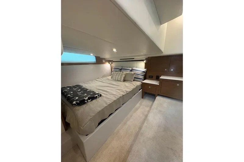  Yacht Photos Pics 2017 Cruisers Yachts 39 Express Coupe cabin with cozy bed and modern wood cabinetry.