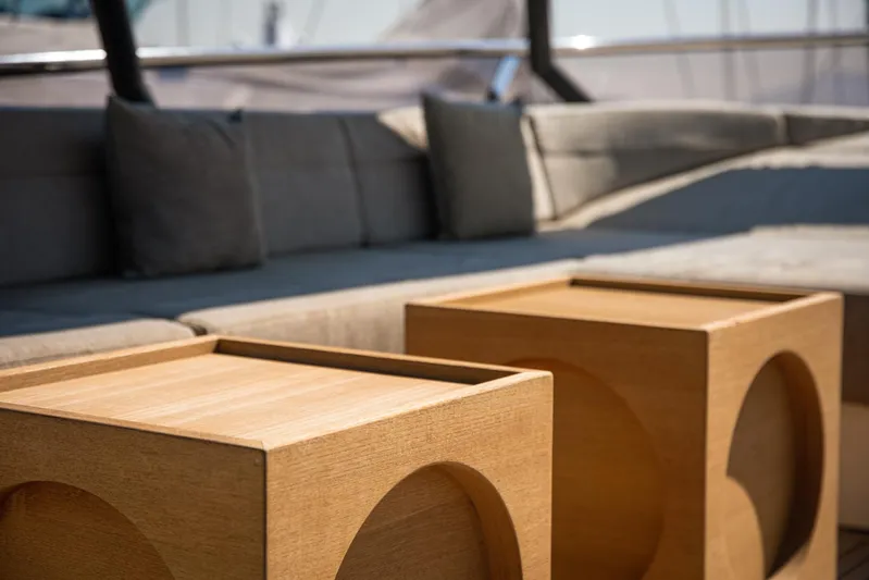 Tyche Yacht Photos Pics Luxurious seating area on 2019 Monte Carlo Yachts MCY 76 with wooden tables.