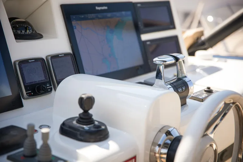 Tyche Yacht Photos Pics Helm of 2019 Monte Carlo Yachts MCY 76 with navigation screens and controls.