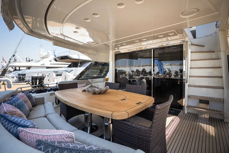 Tyche Yacht Photos Pics Luxurious 2019 Monte Carlo Yachts MCY 76 deck with elegant seating and dining area.