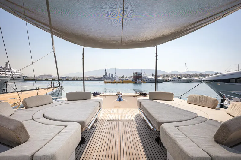 Tyche Yacht Photos Pics Luxurious 2019 Monte Carlo Yachts MCY 76 deck with sun loungers and scenic marina view.