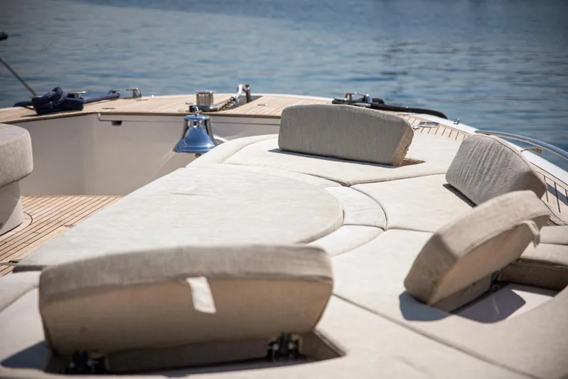 Tyche Yacht Photos Pics Luxurious sunbathing area on 2019 Monte Carlo Yachts MCY 76, featuring plush seating.