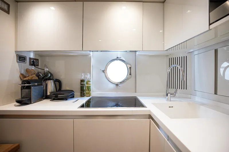 Tyche Yacht Photos Pics Modern kitchen in 2019 Monte Carlo Yachts MCY 76 with sleek design and porthole window.