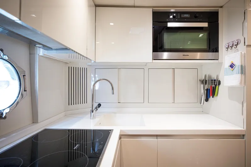 Tyche Yacht Photos Pics Modern kitchen in 2019 Monte Carlo Yachts MCY 76, featuring sleek appliances and minimalist design.