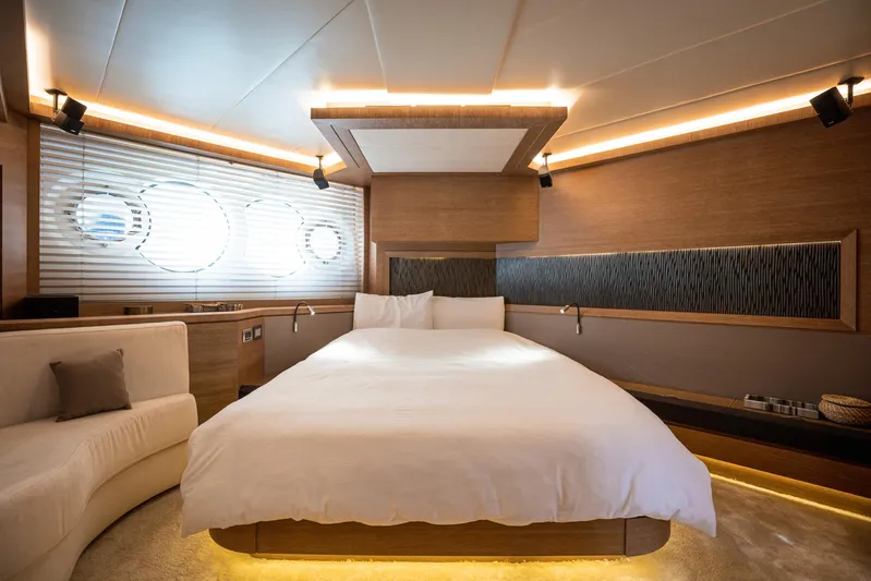Tyche Yacht Photos Pics Luxurious bedroom interior of 2019 Monte Carlo Yachts MCY 76 with modern design and ambient lighting.