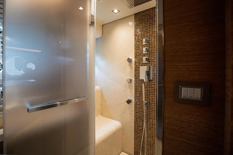 Tyche Yacht Photos Pics Luxurious shower area in 2019 Monte Carlo Yachts MCY 76 with modern fixtures and elegant design.