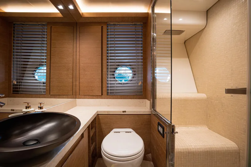 Tyche Yacht Photos Pics Luxurious bathroom on 2019 Monte Carlo Yachts MCY 76, featuring modern fixtures and elegant design.
