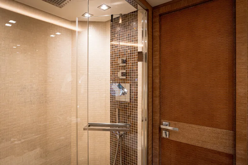 Tyche Yacht Photos Pics Luxurious bathroom interior on 2019 Monte Carlo Yachts MCY 76, featuring elegant glass shower.