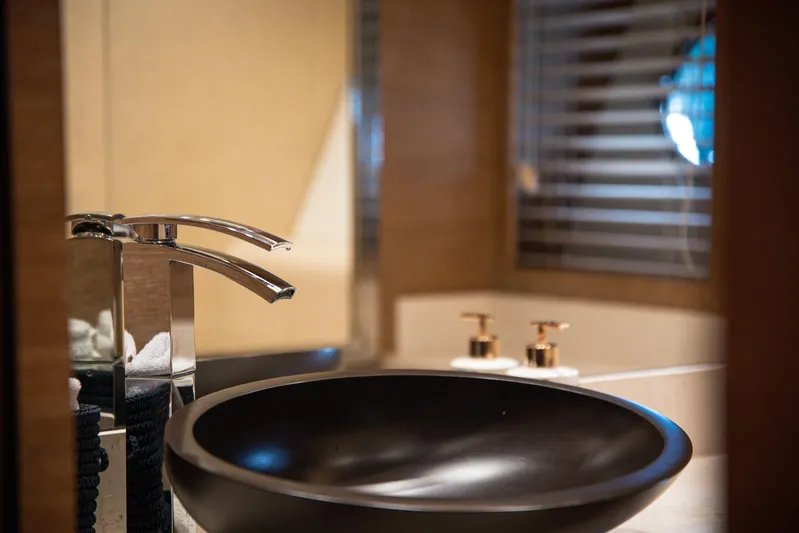 Tyche Yacht Photos Pics Luxurious bathroom sink on 2019 Monte Carlo Yachts MCY 76, featuring modern fixtures.