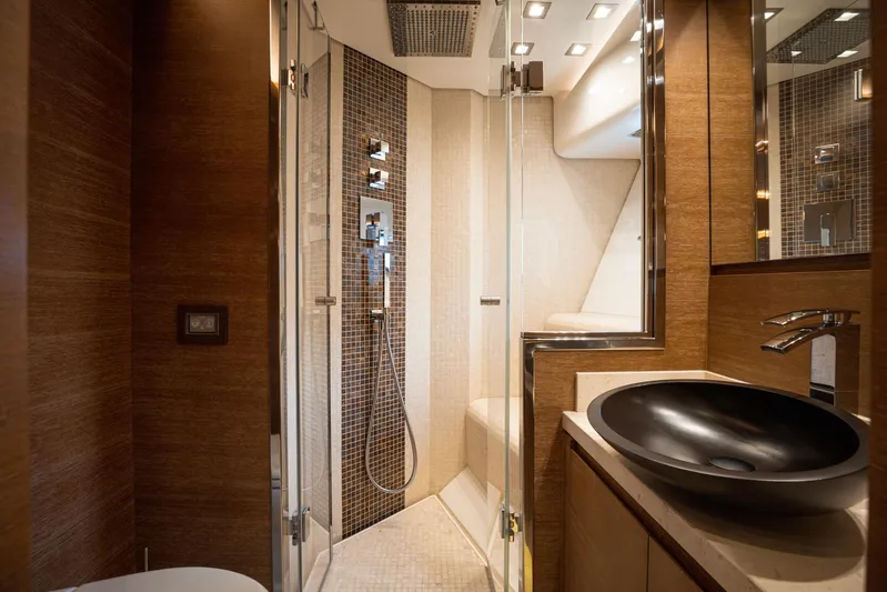 Tyche Yacht Photos Pics Luxurious bathroom in 2019 Monte Carlo Yachts MCY 76, featuring modern fixtures and elegant design.