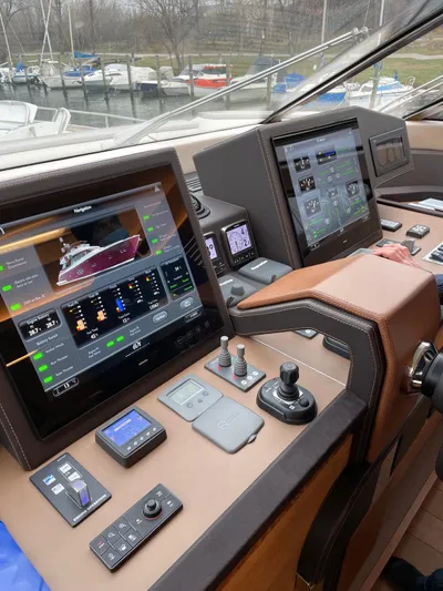 Tyche Yacht Photos Pics Control panel of a 2019 Monte Carlo Yachts MCY 76 with advanced navigation displays.