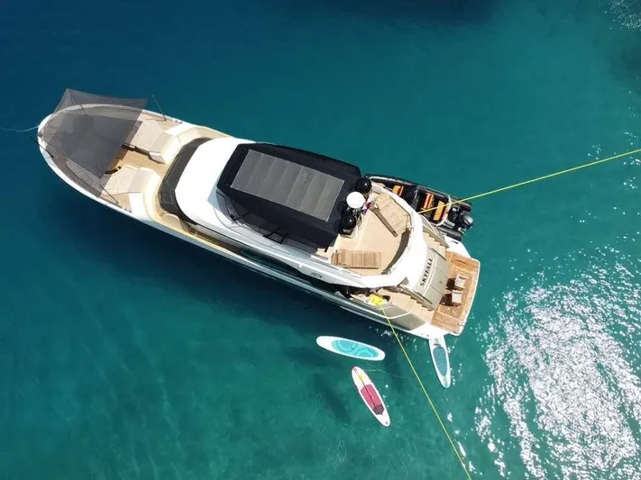 Tyche Yacht Photos Pics Aerial view of 2019 Monte Carlo Yachts MCY 76 anchored with paddleboards nearby.