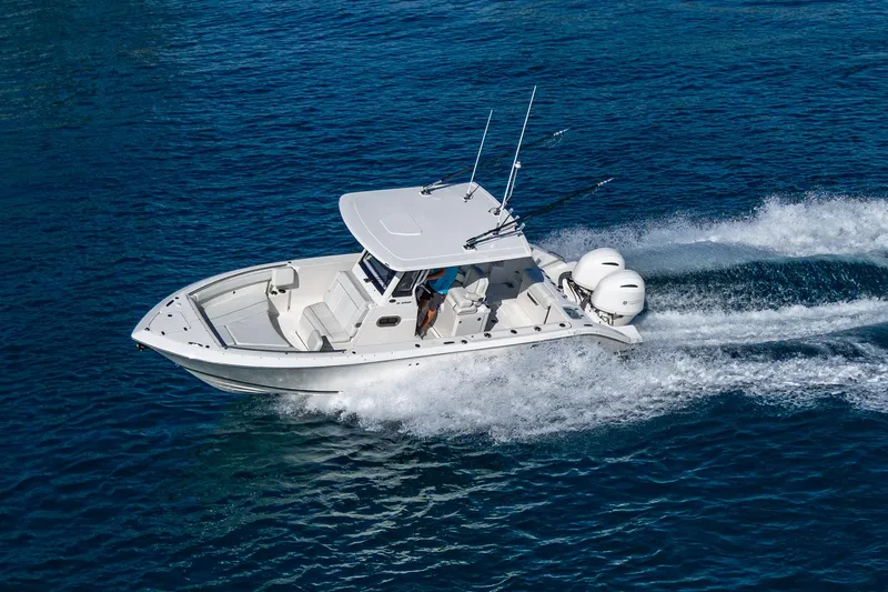 @c Yacht Photos Pics 2022 Pursuit S 268 Sport boat cruising on blue ocean water.