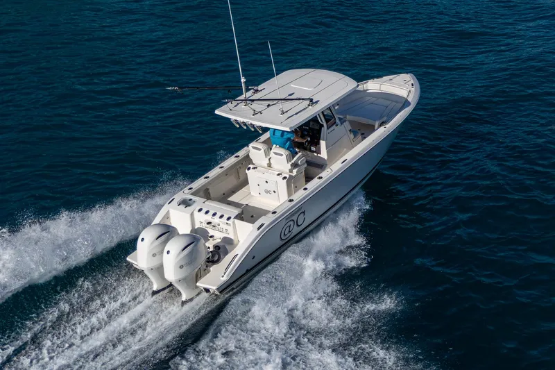 @c Yacht Photos Pics 2022 Pursuit S 268 Sport boat cruising on open water, showcasing twin engines.