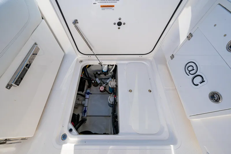 @c Yacht Photos Pics 2022 Pursuit S 268 Sport boat storage compartment with open hatch.