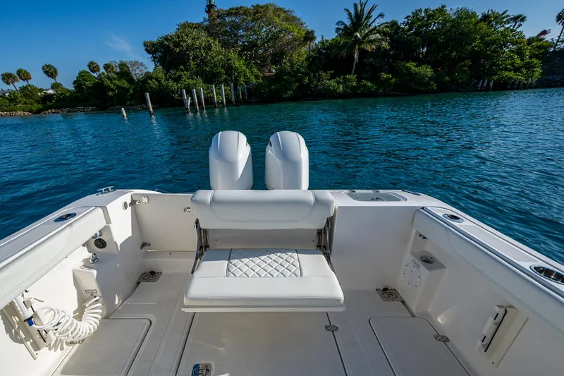 @c Yacht Photos Pics 2022 Pursuit S 268 Sport boat interior with dual engines on a scenic waterway.